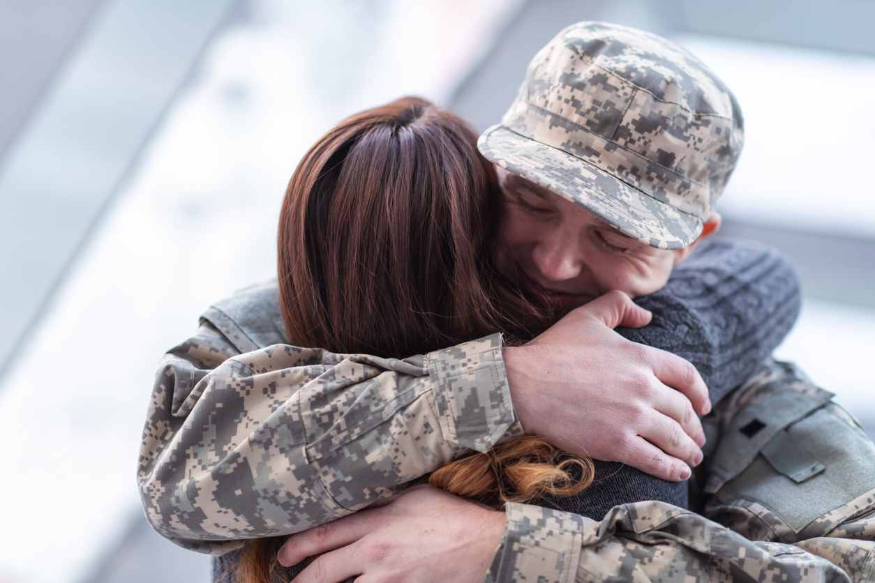 military spouse green card processing time soldier hugging wife