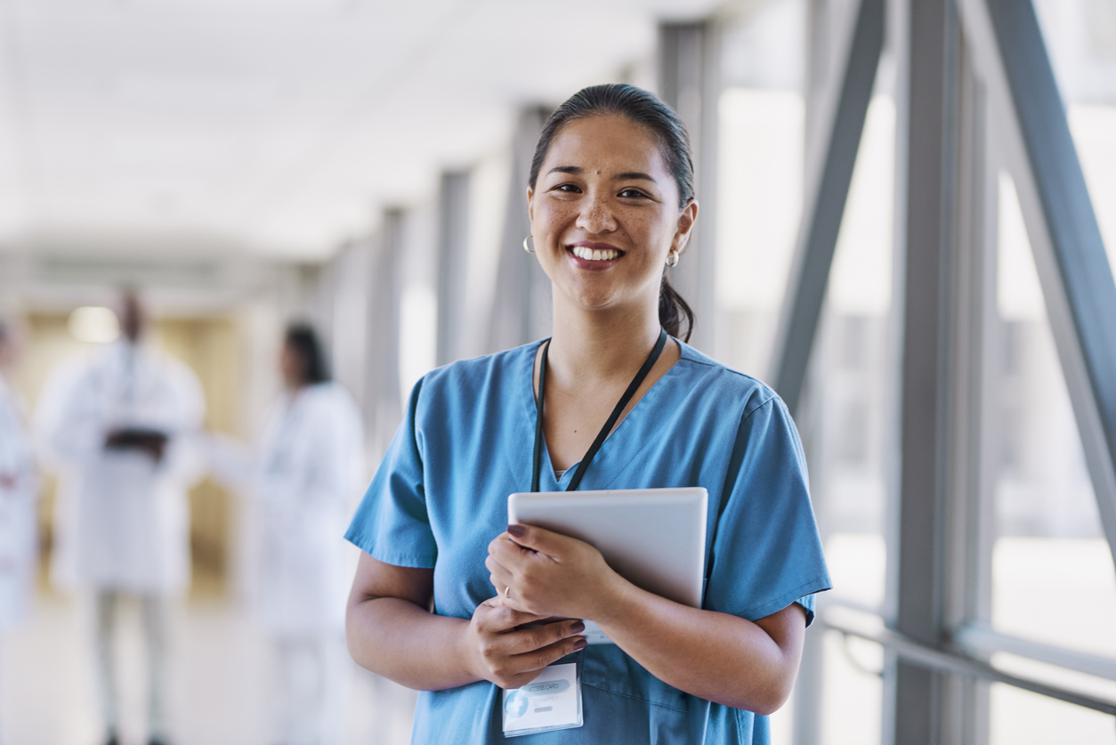 EB-3 for international nurse immigration smiling nurse in hospital corridor