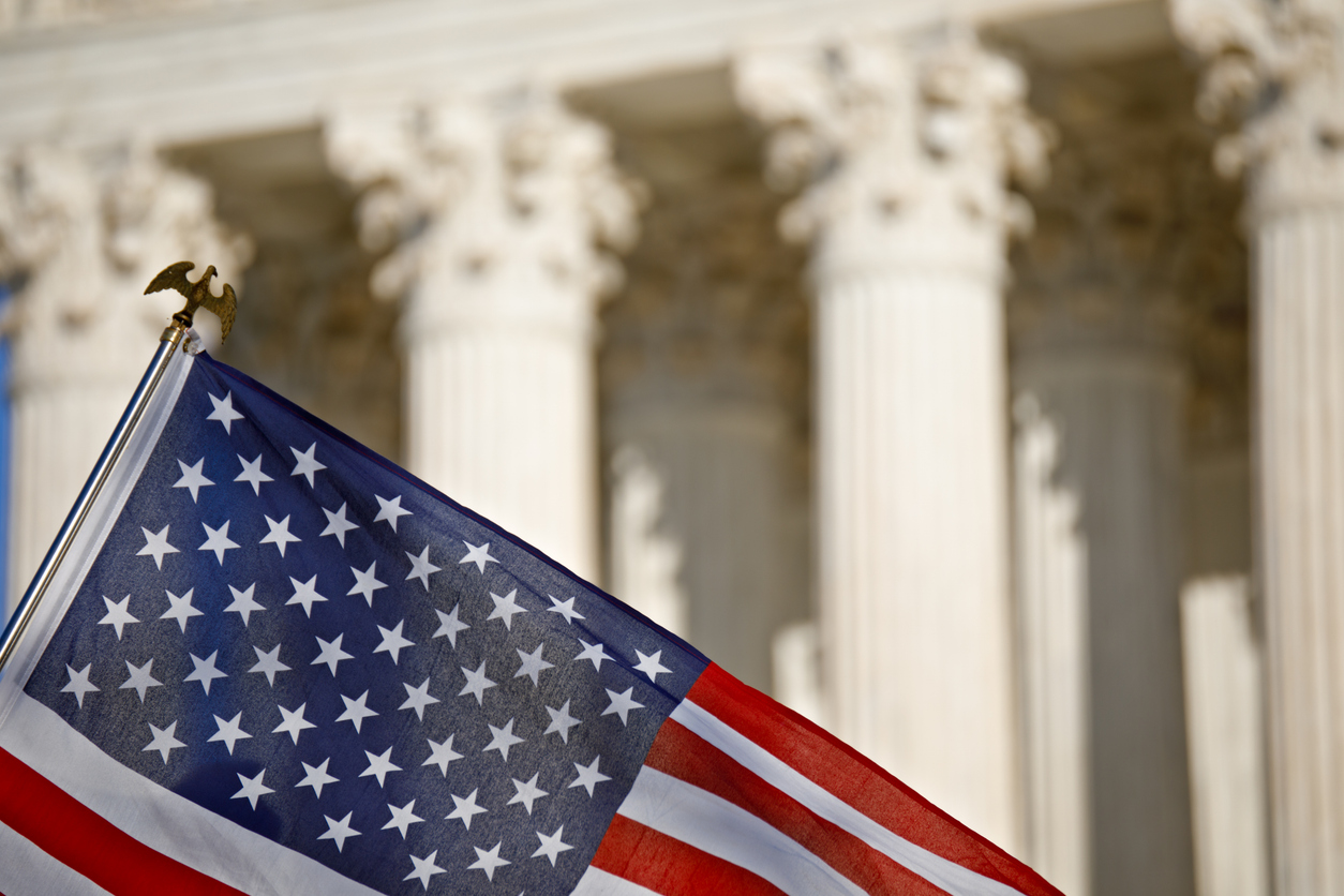 deportation defense us flag in front of court building